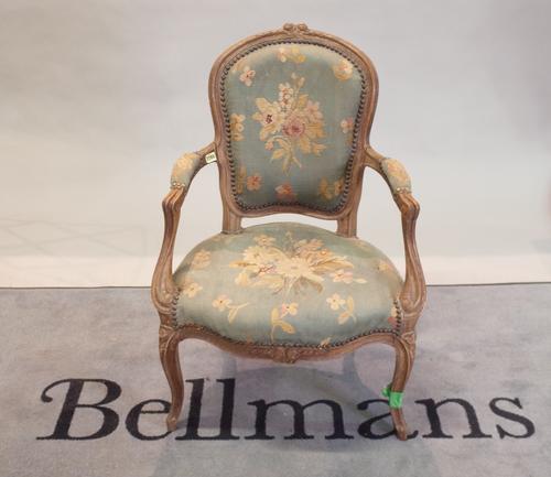 A 19th century walnut framed open armchair, with needlework upholstered back and seat, 60cm wide x 90cm high.