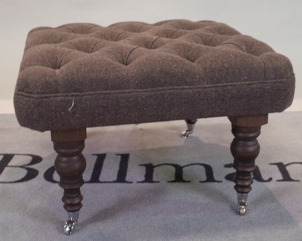 A modern grey upholstered square footstool, on turned ebonised supports, 72cm wide x 45cm high.
