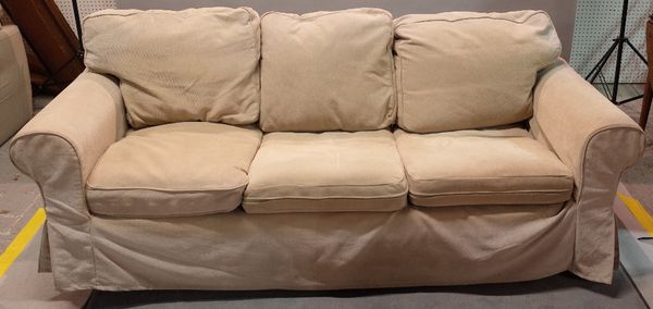 A modern hardwood framed three seater sofa on block supports, 215cm wide x 73cm high.