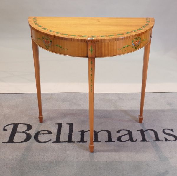 A George III style satinwood and painted 'D' shape console table on tapering square supports, 83cm wide x 83cm high.