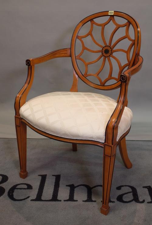 A Regency style stained beech and parcel ebonised open armchair, 59cm wide x 94cm high.
