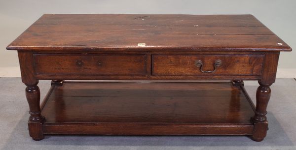 An 18th century style oak, two drawer coffee table, 122cm wide x 55cm high.