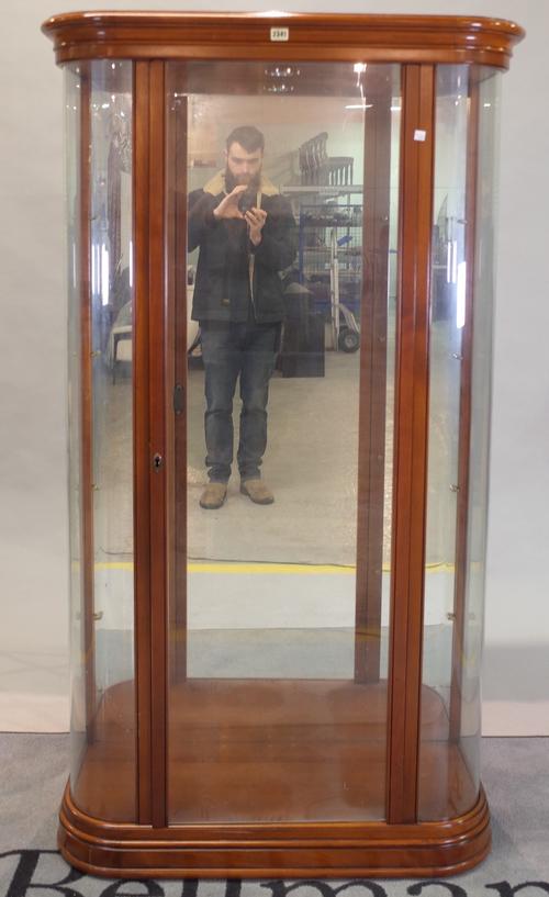 A modern fruitwood floor standing display cabinet with glass front, on plinth base, 90cm wide x 167cm high.