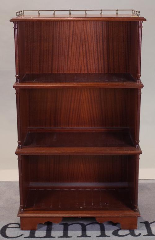 A  mahogany three tier open waterfall bookcase on bracket feet, 65cm wide x 114cm high.