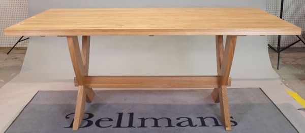 A modern oak rectangular dining table, on 'X' frame supports united by a stretcher, 91cm wide x 180cm long.