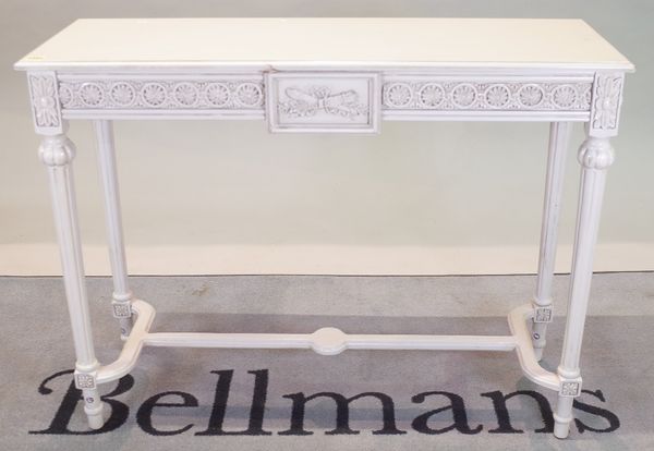 A modern white painted Continental side table with on fluted tapering supports, 105cm wide x 81cm high.