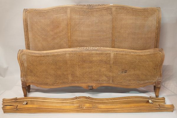 A stained beech and canework double bed, 117cm wide x 118cm high.