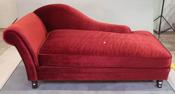 A modern hardwood framed chaise longue with red upholstery on tapering supports, 175cm wide x 87cm high.