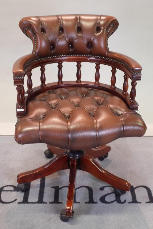 A modern stained beech office open armchair with brown leather buttonback upholstery, 62cm wide x 91cm high.