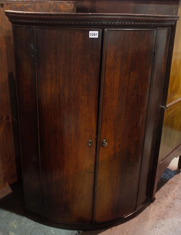 An 18th century mahogany bowfront hanging corner cupboard, 70cm wide x 98cm high.