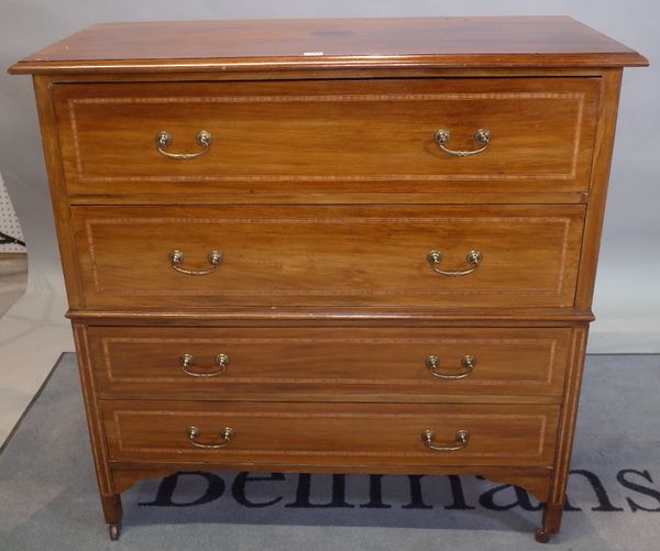 An Edwardian inlaid mahogany chest of four long graduated drawers on tapering square supports, 106cm wide x 107cm high.