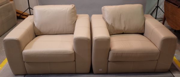 A pair of modern low armchairs with grey leather upholstery, 107cm wide x 50cm high, (2).