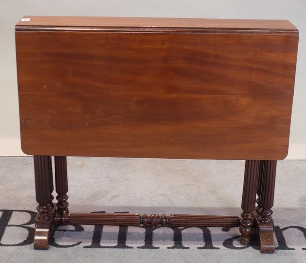 A William IV mahogany drop flap side table on reeded column supports, 81cm wide x 73cm high.