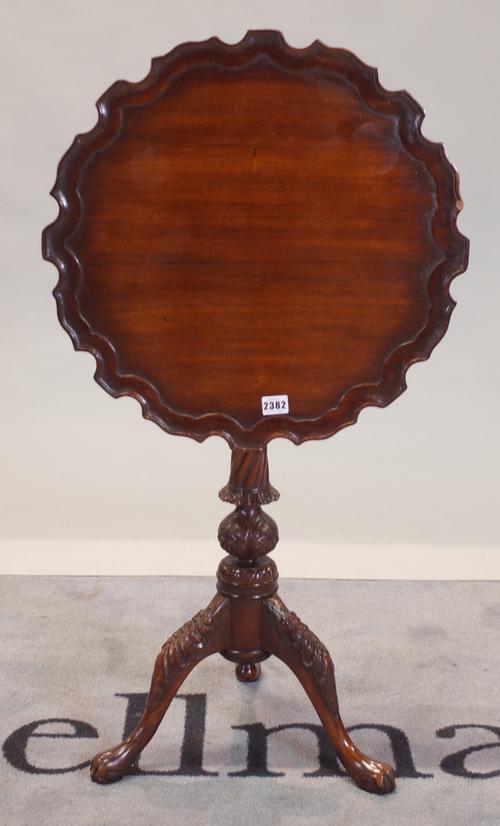 An 18th century style mahogany tripod table with piecrust top and carved column on three downswept supports, 81cm wide x 73cm high.