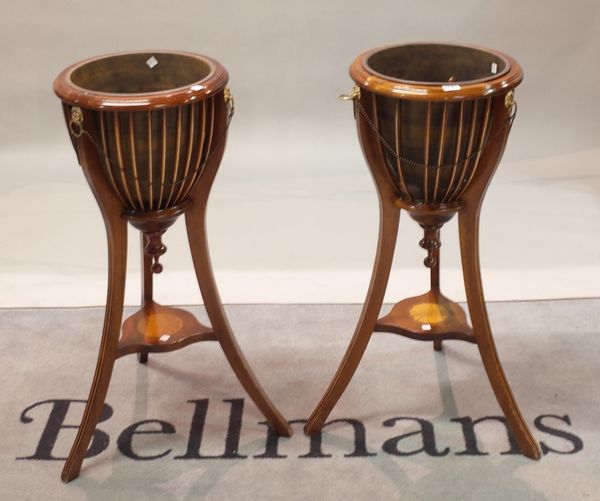 A pair of Regency style urn shaped slatted tripod jardinieres, 35cm wide x 85cm high, (2).