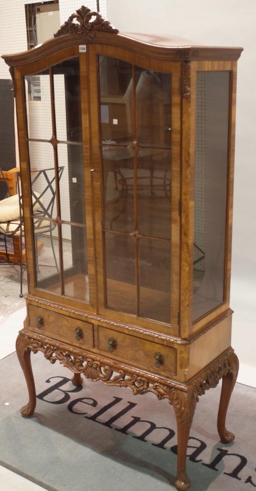 An 18th century style walnut display cabinet with arch top over pair of glazed doors and pair of drawers, 86cm wide x 178cm high.
