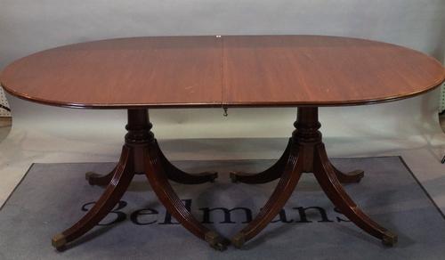A mahogany twin pillar Regency style dining table with an extra leaf, 114cm wide x 180cm long x 275cm long extended.