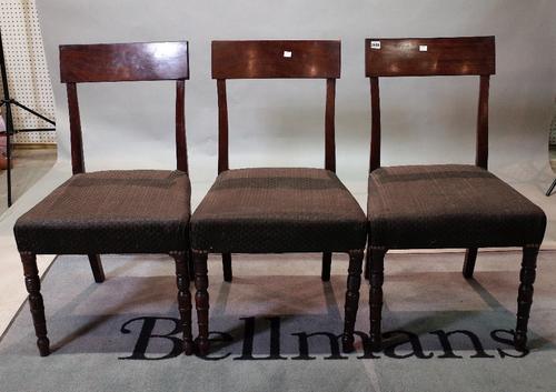 A set of five late George III mahogany dining chairs, with curved top rails, stuff-over seats, on ring turned legs, re-railed, 50cm wide x 89cm high...