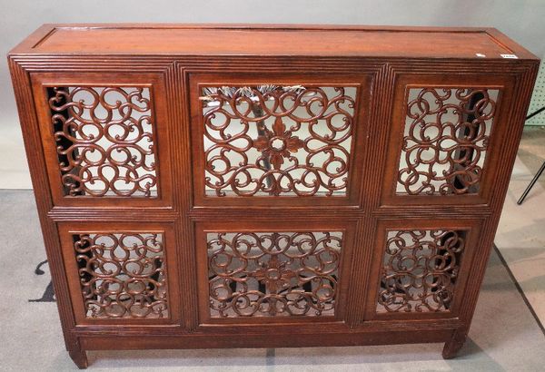 A late 19th century Chinese hardwood side cabinet fronted with six pierced scroll panels, on tapering square supports, alterations, 112cm wide x 92cm...