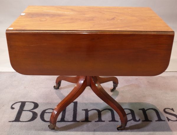 A George III mahogany ebony strung supper table, with hinged drop leaves and end drawer, ring turned pillar and quadripartite base, 91.5cm wide x...