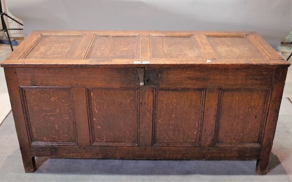 A 17th century oak coffer with four panelled lid and front on stile feet, 63cm high x 130cm wide.