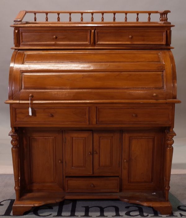 A Chinese hardwood cylinder front desk, 20th century, with drawers above and below the cylinder front, 104cm wide x 129cm high.