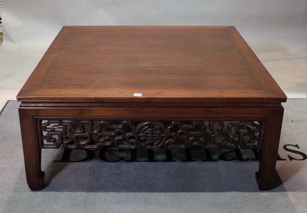 A large Chinese hardwood low centre table, 20th century, with pierced and carved friezes, on shaped square legs, 106cm wide x 46cm high.