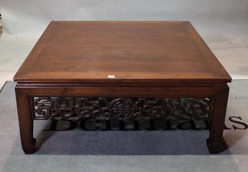A large Chinese hardwood low centre table, 20th century, with pierced and carved friezes, on shaped square legs, 106cm wide x 46cm high.