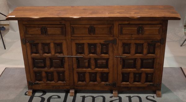 A Spanish sideboard, of raised and fielded panelled construction, with three drawers and cupboards under, 150cm wide x 80cm high.