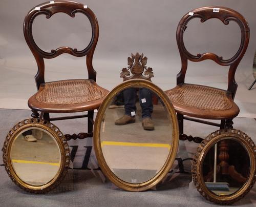 A Victorian oval moulded giltwood frame wall mirror, with associated carved stag head capital, 71cm high, a pair of Victorian balloon back cane seat...