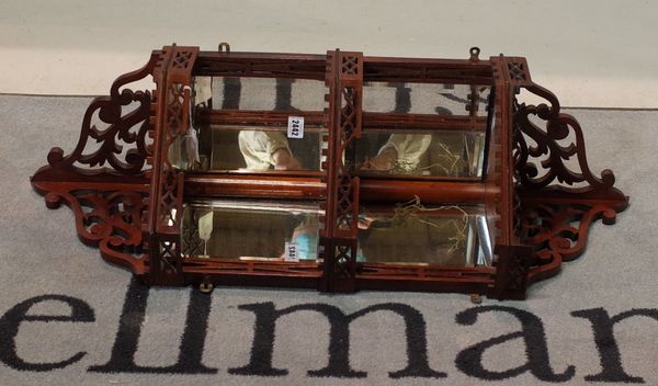 A set of Edwardian mahogany fret carved three-tier corner wall hanging shelves, mirror backed, 90cm high x 34cm wide.