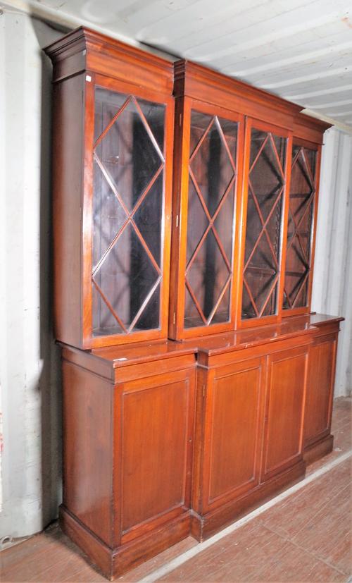 A late George III mahogany breakfront bookcase with astragal glazed doors over cupboard base, 182cm wide x 220cm high.
