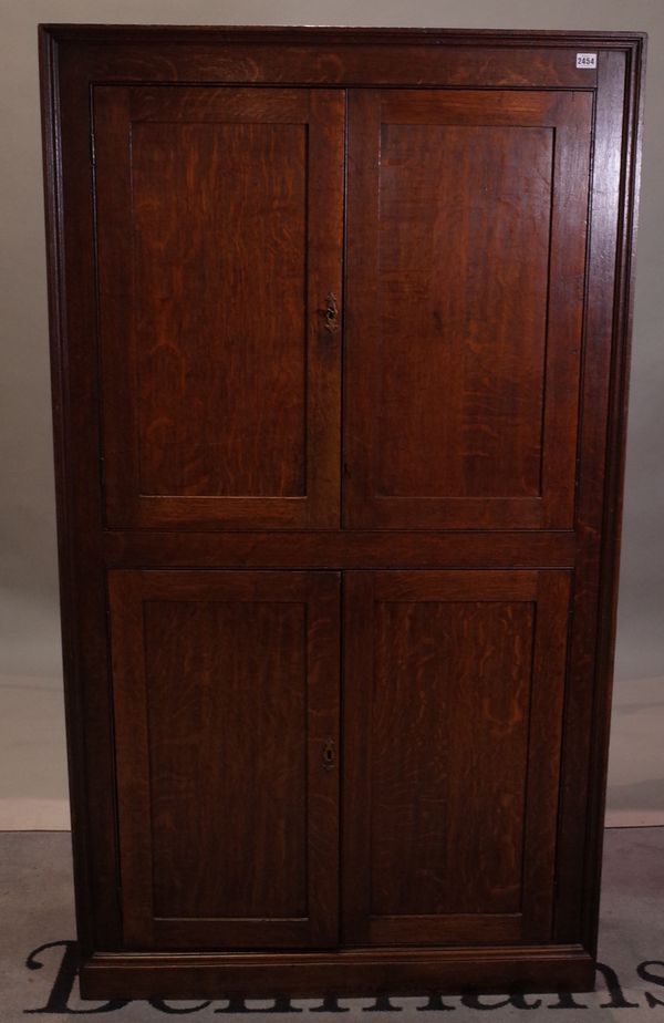 A late 18th century oak floorstanding four door corner cabinet, 96cm wide x 173cm high.