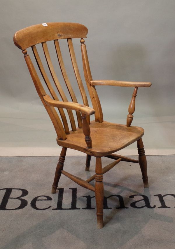 A late 19th century ash and elm kitchen open armchair, on turned supports, 45cm wide x 103cm high.