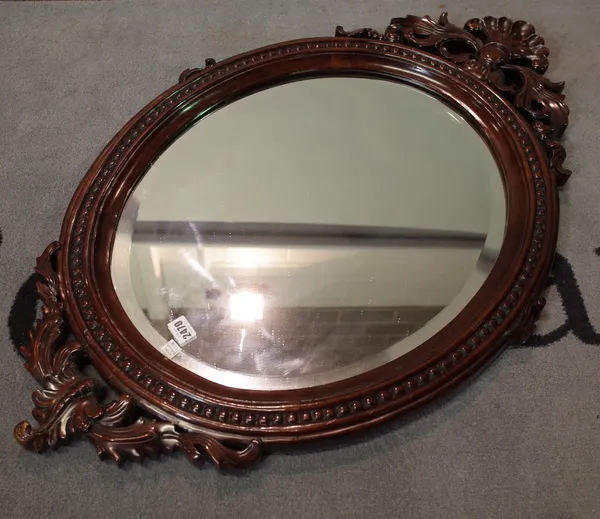 A Victorian style stained beech oval wall mirror, 61cm wide x 96cm high.