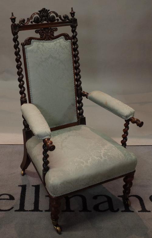 A Victorian rosewood framed low open armchair, on barley-twist supports, 59cm wide x 102cm high.