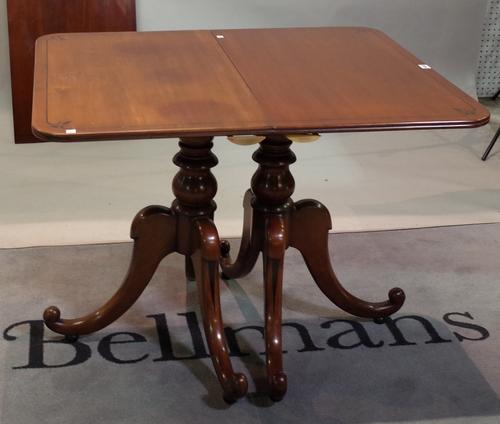 A Regency style mahogany 'D' end dining table on turned column and outswept supports, with an extra leaf, 116cm wide x 180cm long x 210cm fully...