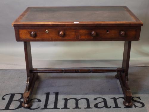 An early Victorian mahogany two drawer writing table on bun feet, 92cm wide x 76cm high.