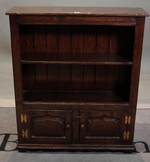 An 18th century style oak two tier open bookcase with cupboard  base, 84cm wide x 98cm high.
