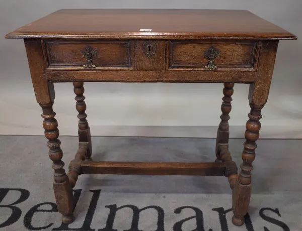 An 18th century style oak single drawer side table on bobbin turned supports, 79cm wide x 73cm high.