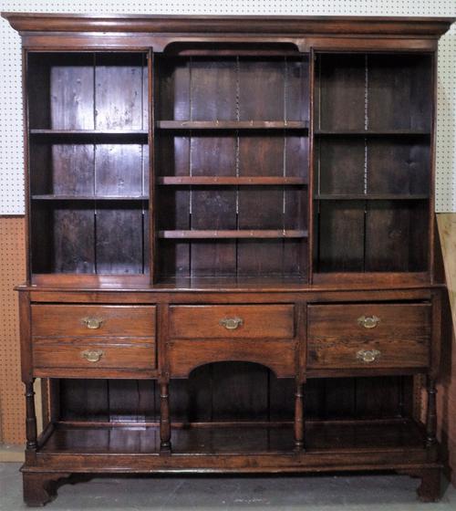 An early 20th century oak dresser with three tier plate rack over three frieze drawers, on bracket feet, 188cm wide x 209cm high.