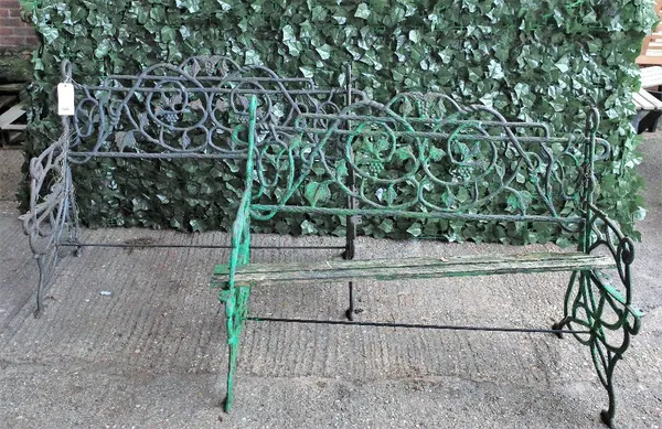A pair of cast iron garden benches with fruiting vine decoration, 120cm wide x 83cm high, (a.f.), (2).