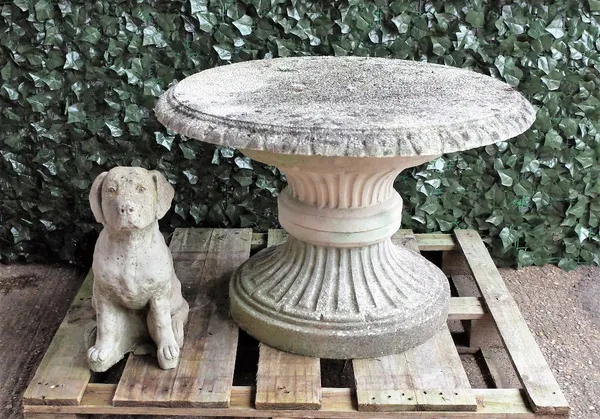 A reconstituted stone circular table on flared base, 90cm diameter x 62cm high, and a seated figure of a dog, 50cm high, (2).