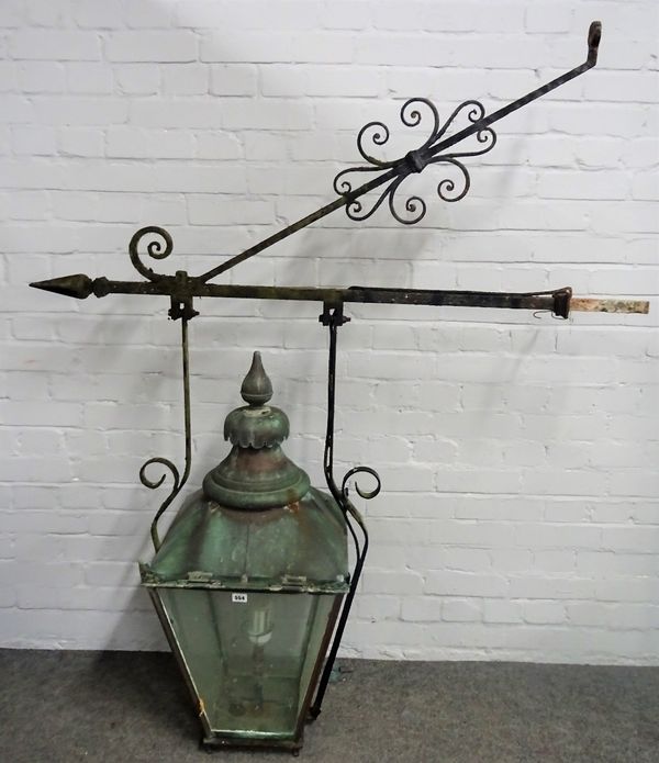 A Victorian copper street lantern, mounted on a cast iron wall bracket, the lantern approximately 80cm high.