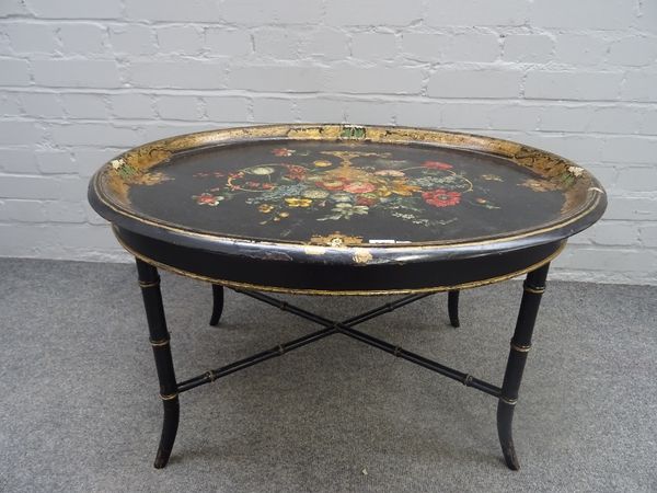 A Victorian polychrome floral painted oval papier mache tray on a later faux bamboo stand, 81cm wide x 48cm high.