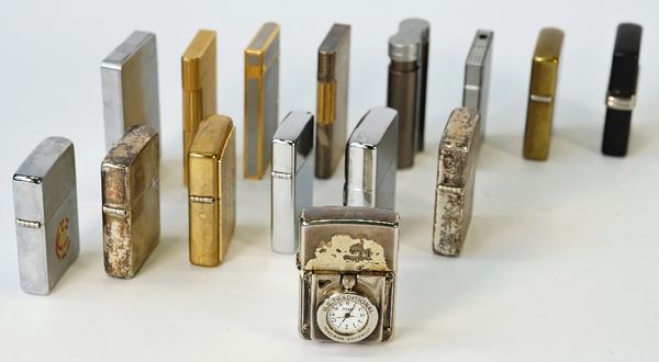 A collection of fifteen various lighters, comprising; two sterling silver cased Zippo lighters, six other Zippo lighters, one lacking interior, two...