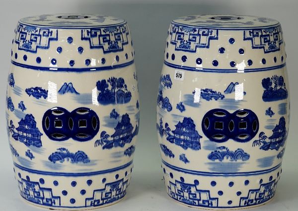 A pair of modern Chinese style blue and white porcelain garden seats, each decorated with landscape scenes against a pierced barrel form ground, 46cm...