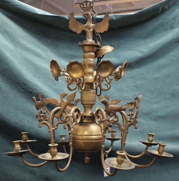 A brass eight light chandelier, the scroll branches having bird finials, in the 17th century style, 68cm high x 68cm diameter.