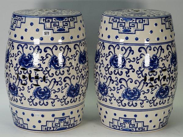 A pair of modern Chinese style blue and white porcelain garden seats, each foliate decorated against a pierced barrel form ground, 45cm high, (2).