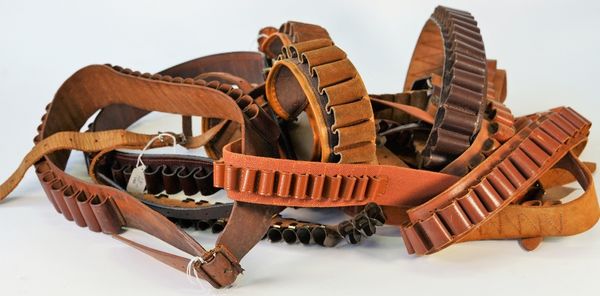 Eleven cartridge belts, of various gauges, including three leather bound, suede and canvas examples, (11).